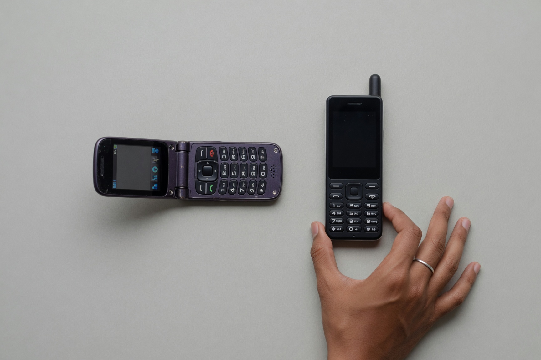 Candybar and flip dumbphones side by side for form factor comparison