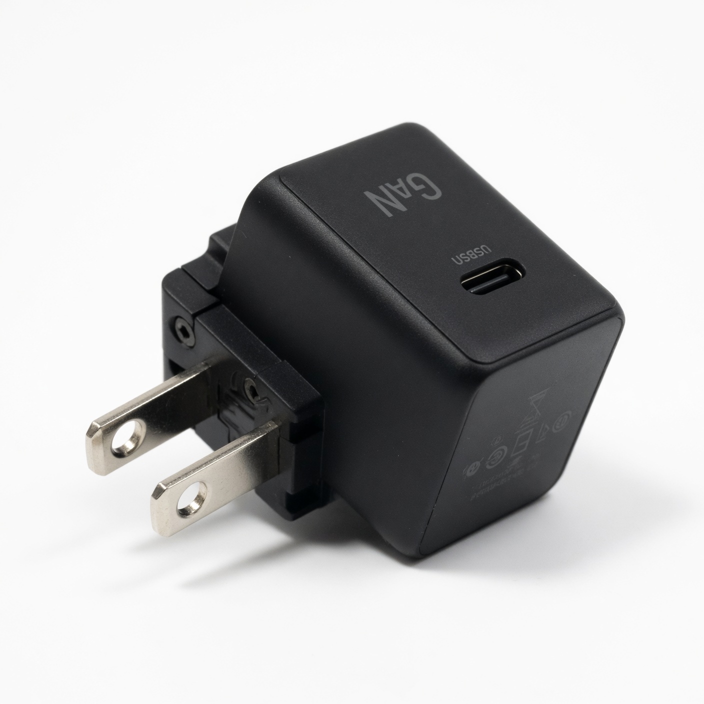 Compact GaN USB-C wall charger with folding plug prongs on white background