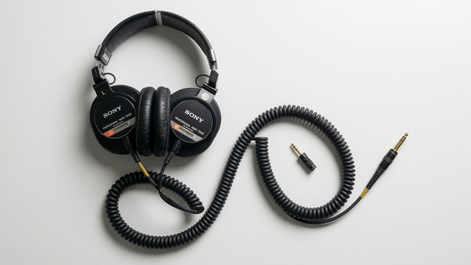 Sony MDR-7506 professional over-ear wired headphones flat lay on white surface